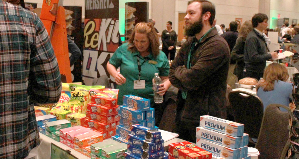 trade show picture of vendors at food table