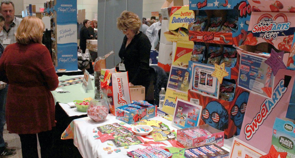 trade show picture of vendors at food table