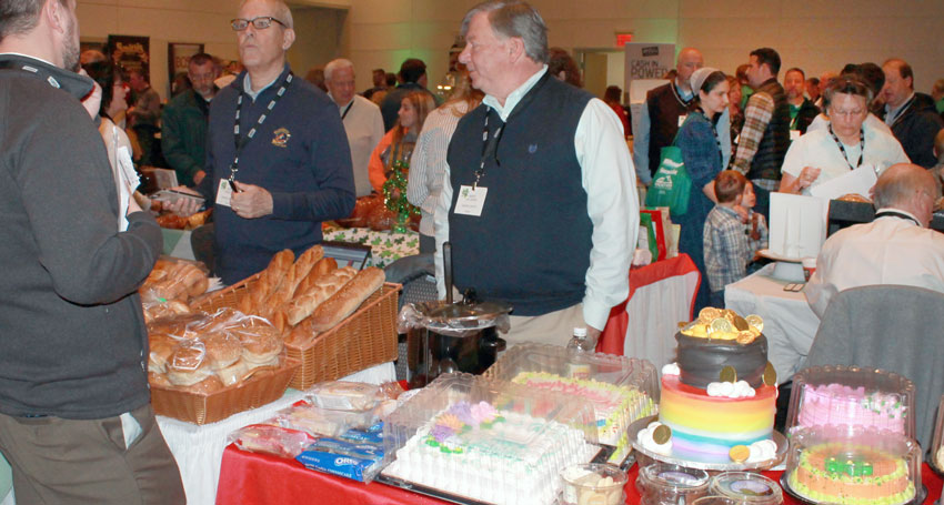 trade show picture of vendors at food table talking to customers